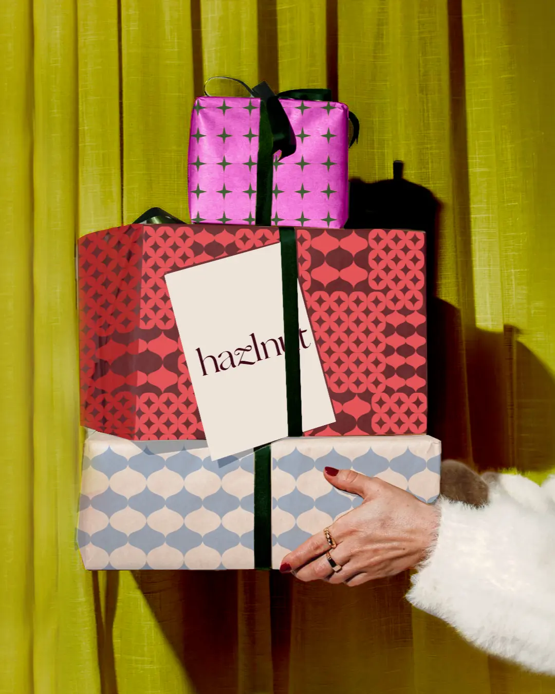 A stack of gifts wrapped in Hazlnut motif paper